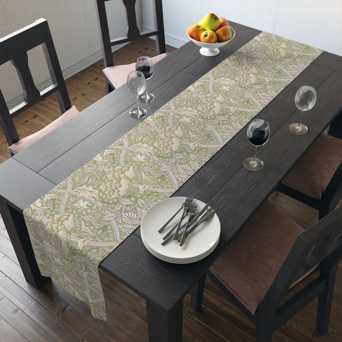 Dining table with a patterned table runner, plates, and glasses in a room.
