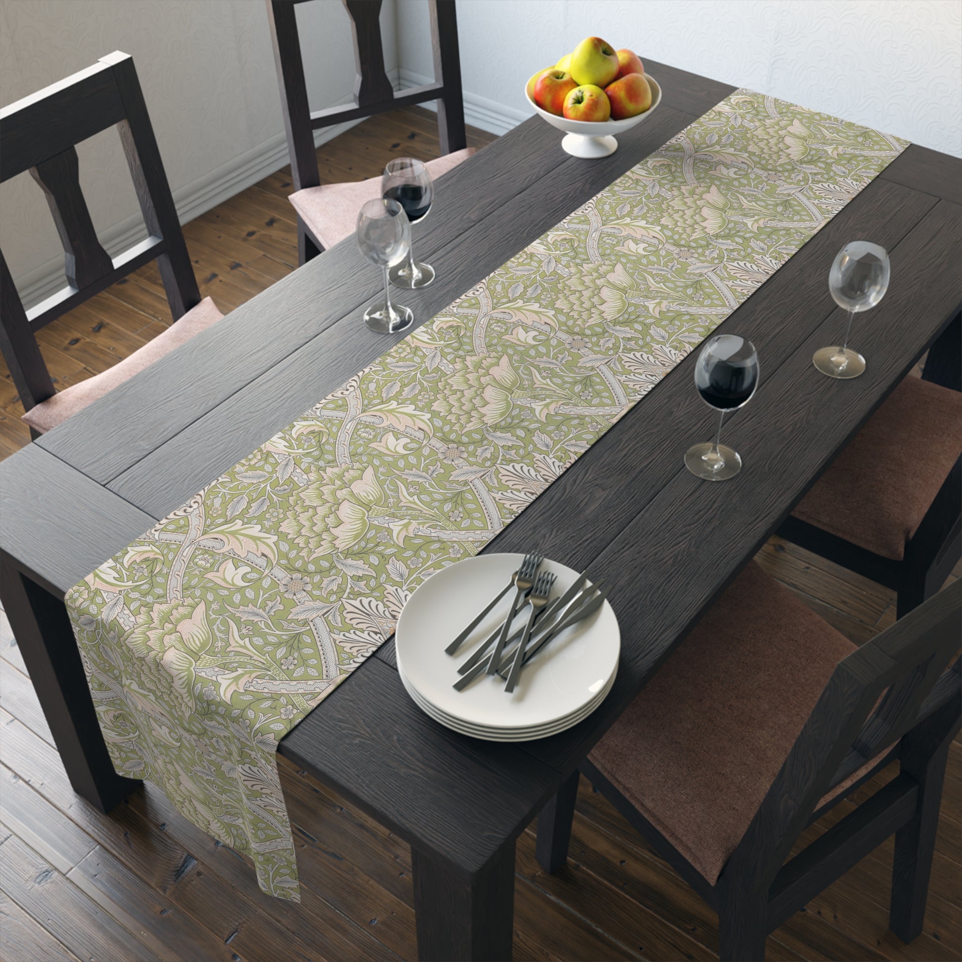 Dining table with a patterned table runner, plates, and glasses in a room.