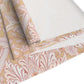 Roll of floral-patterned fabric on a white background