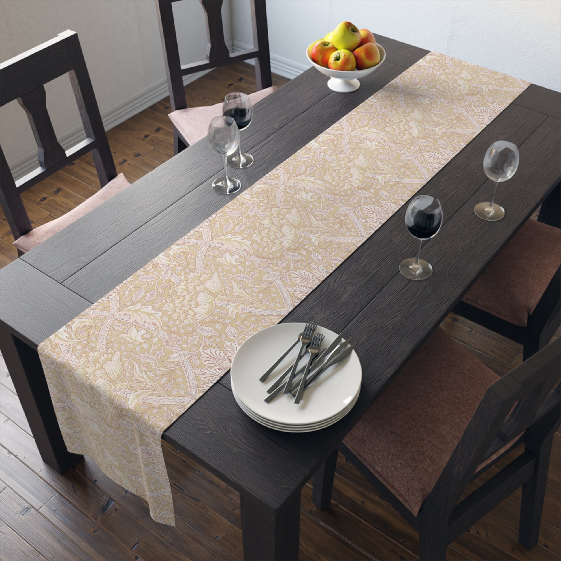 Dining table with a patterned tablecloth, plates, and glasses in a room.
