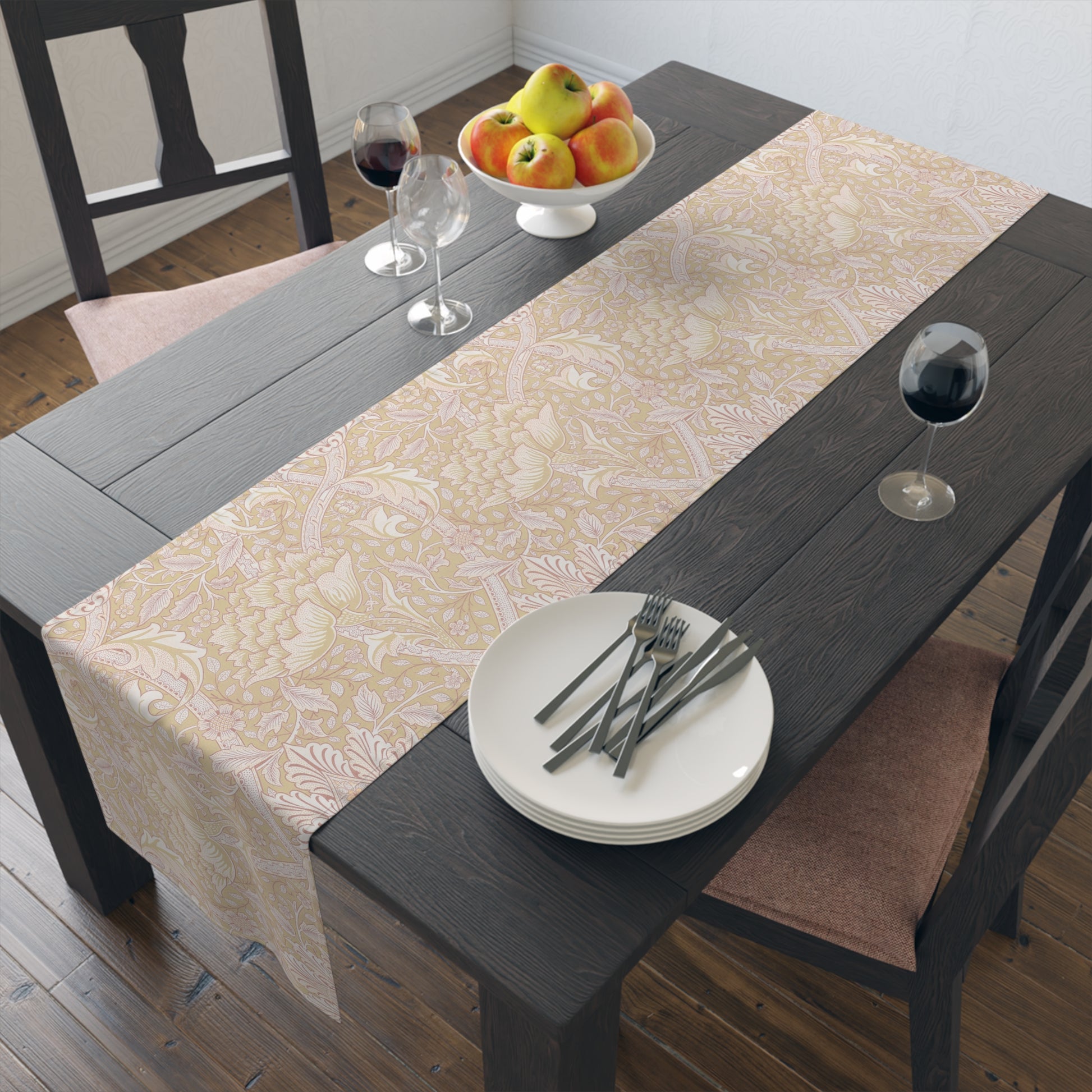 Dining table with a patterned table runner, plates, forks, and a fruit bowl.