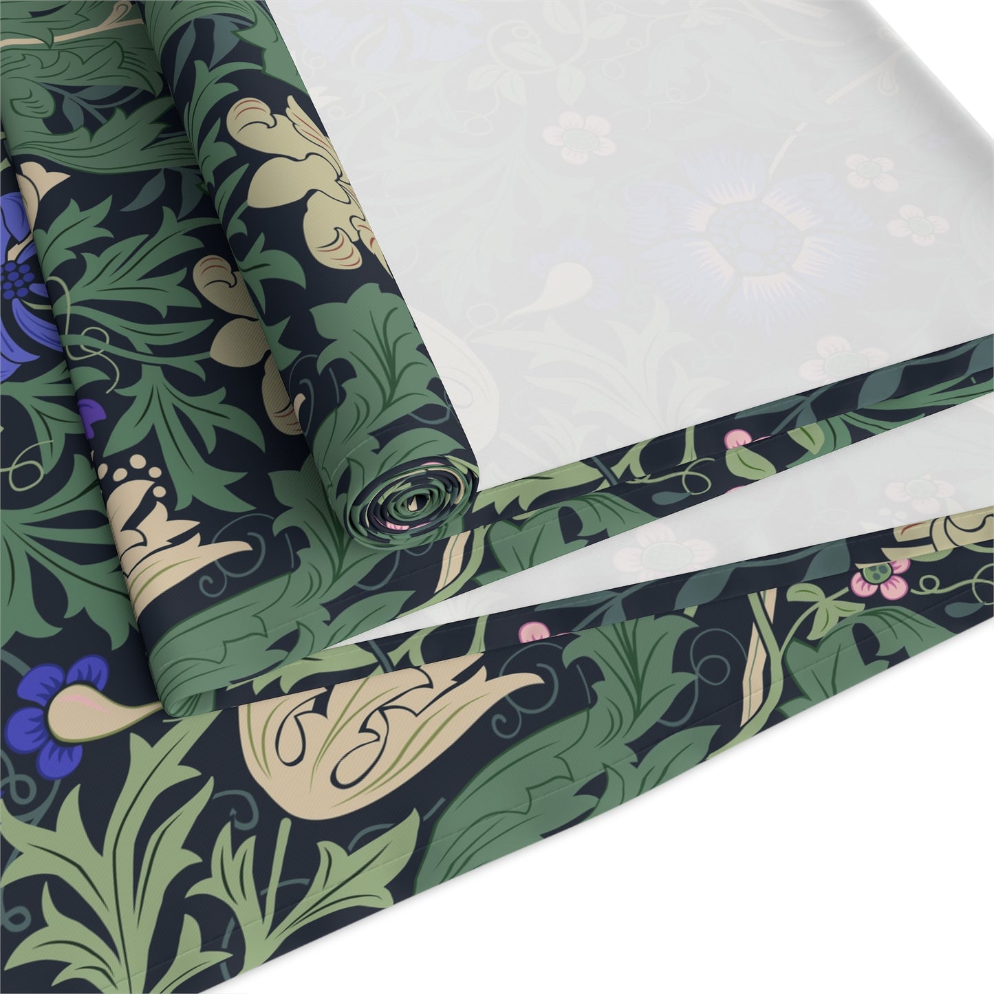 Roll of fabric with a green and black floral pattern on a white background