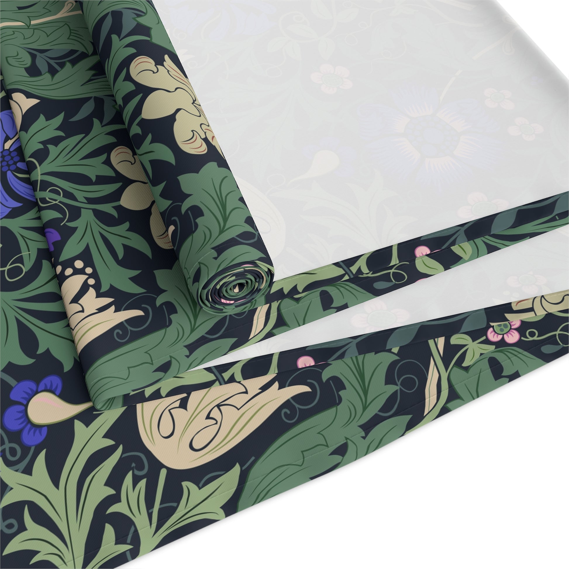 Roll of fabric with a green and black floral pattern on a white background