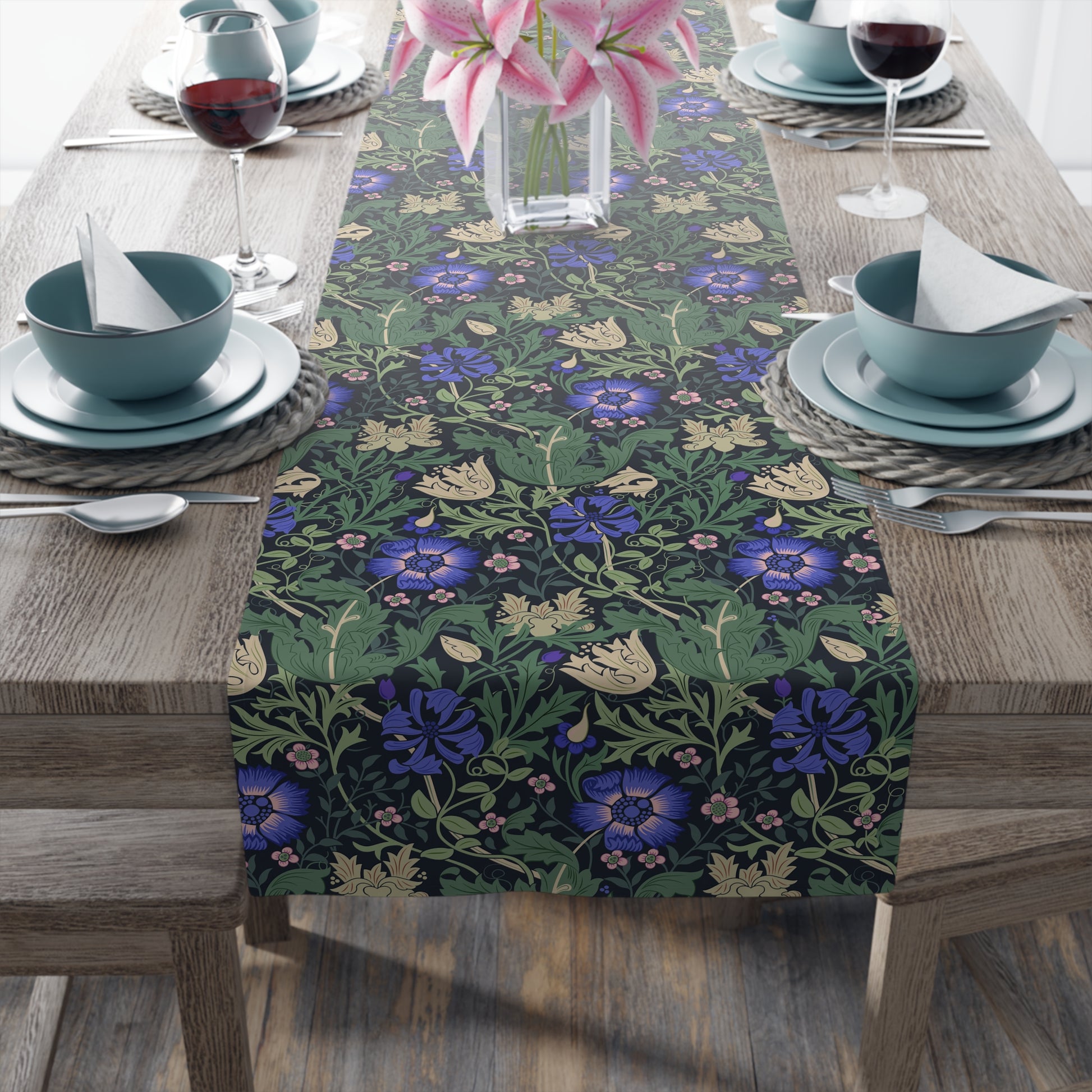 Floral patterned table runner on a wooden table with dining setup.
