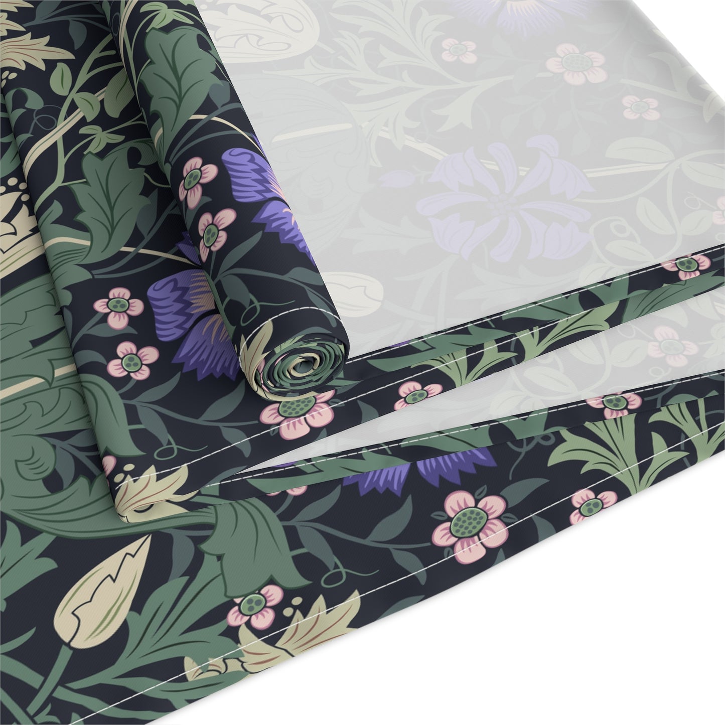 Roll of floral-patterned fabric with green, purple, and pink colors on a white background.