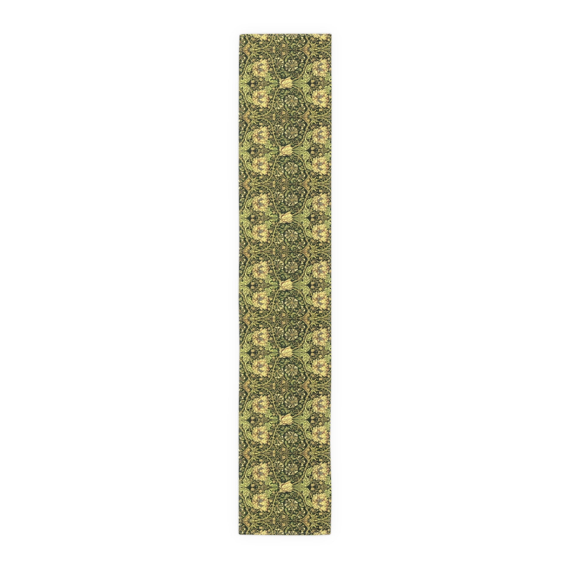 A floral patterned table runner in gold and green shades, laid out on a dining table with place settings and decorative flowers.
