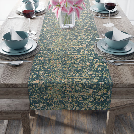 A table runner with a green and gold William Morris & Co pattern displayed on a dining table setting with dishes and glasses.