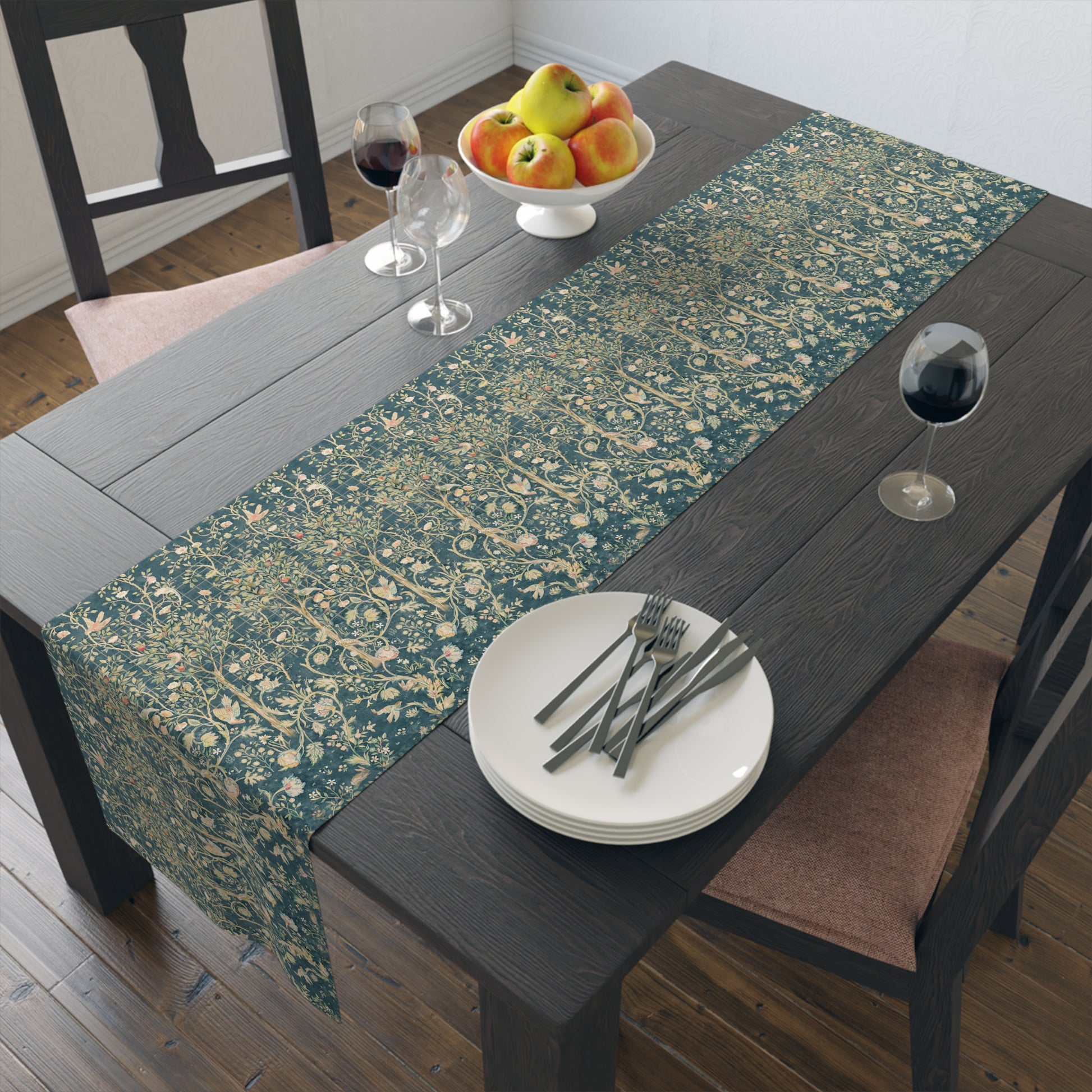 A table runner with a green and gold William Morris & Co pattern displayed on a dining table setting with dishes and glasses.