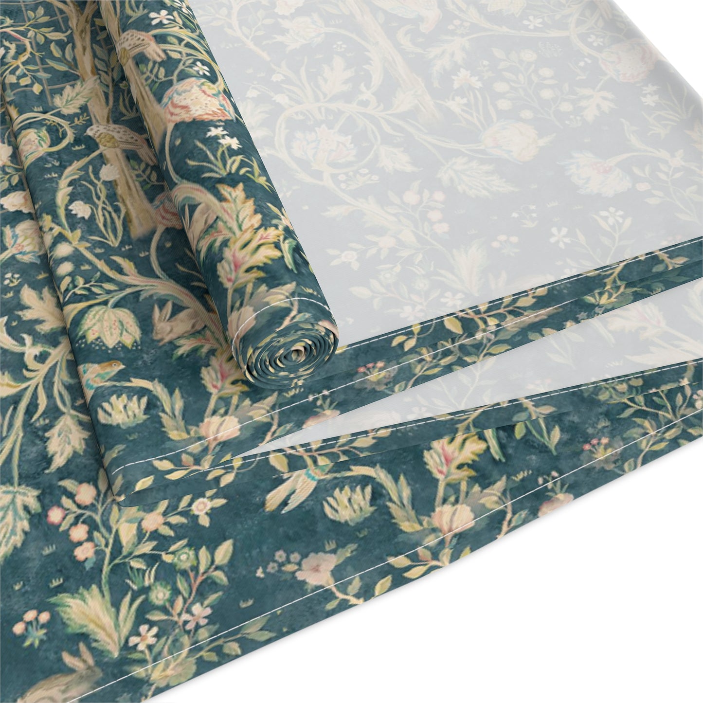 A table runner with a green and gold William Morris & Co pattern displayed on a dining table setting with dishes and glasses.