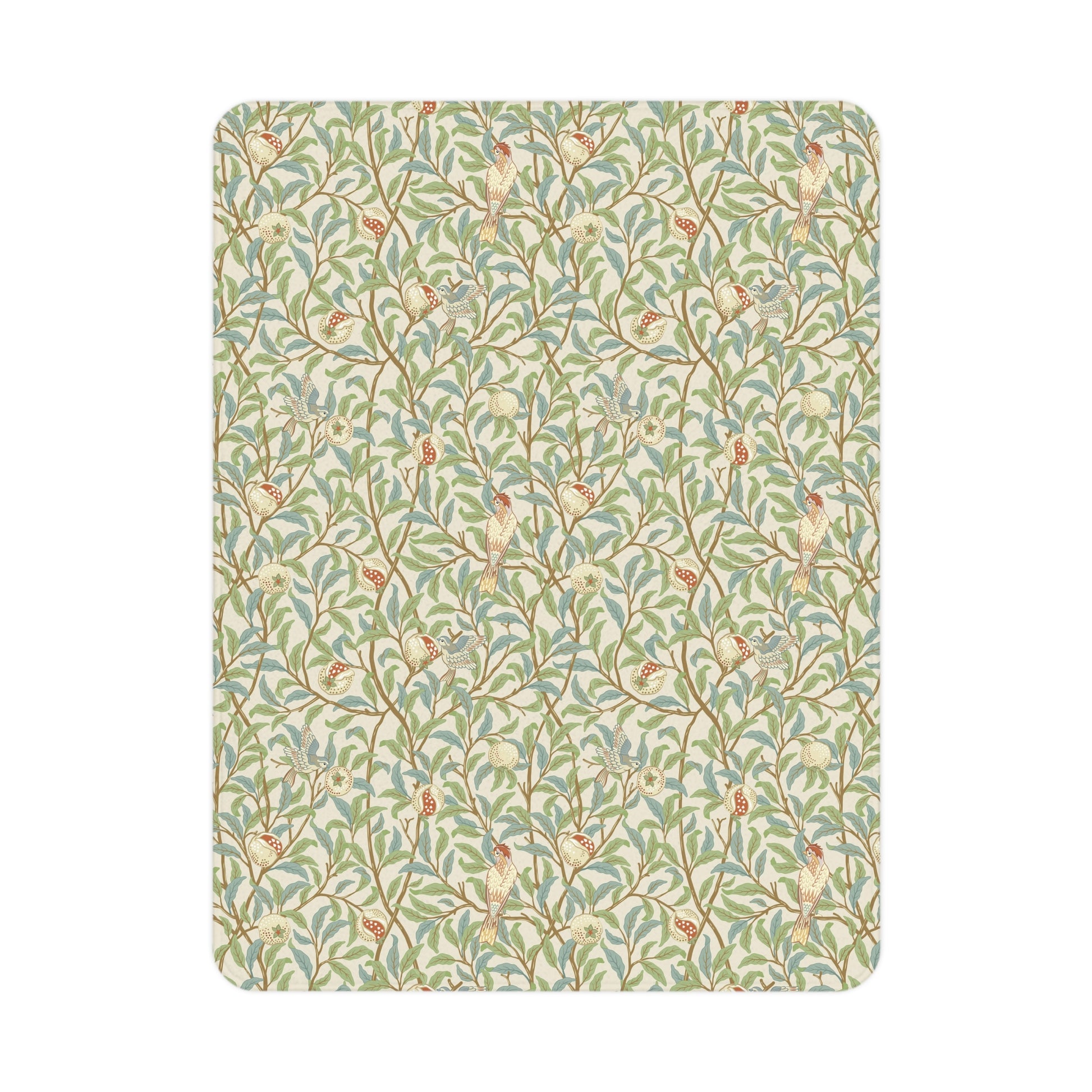 A toddler blanket with a floral pattern featuring birds and pomegranates in green, red, and beige colours on a parchment background.