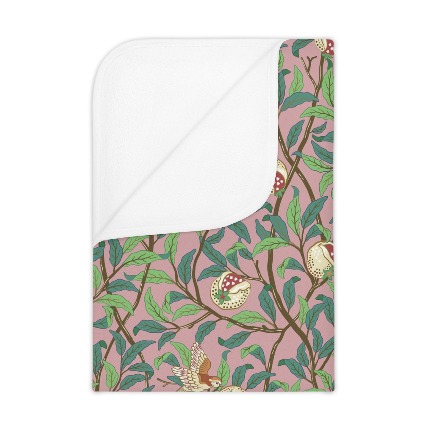 A toddler blanket with a floral pattern featuring birds and pomegranate designs on a pink background.