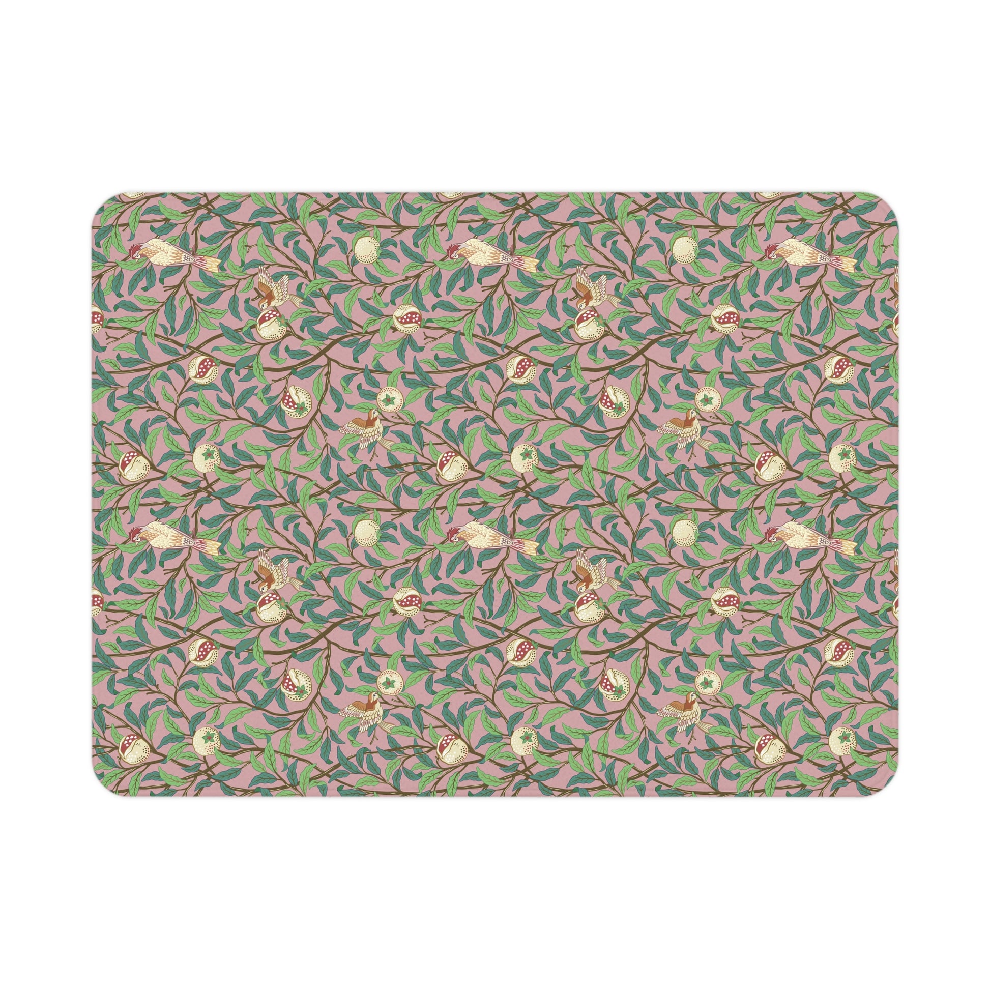 Patterned mat with floral and branch design on a pink background