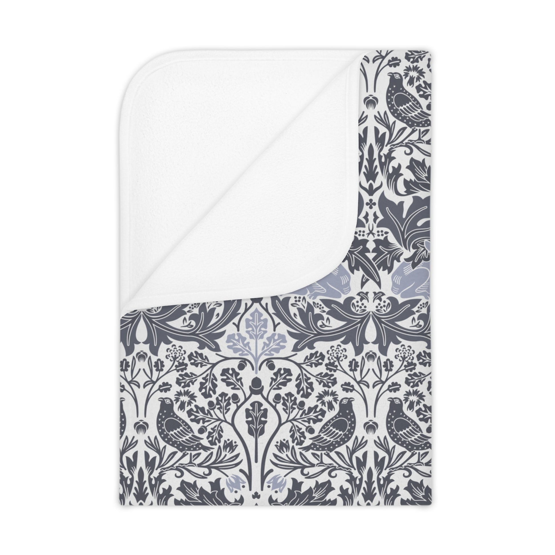 A gray toddler blanket with a floral pattern inspired by William Morris, displayed folded with the patterned side visible.