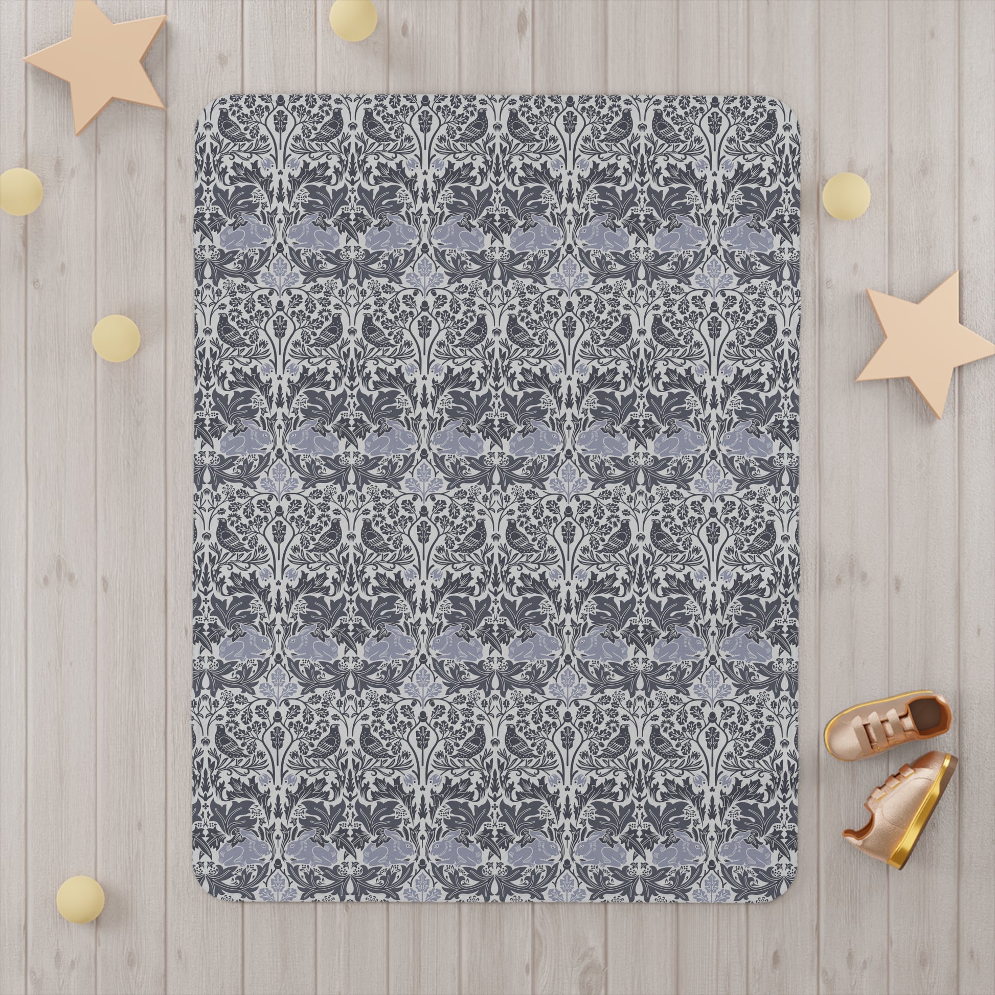 Decorative throw blanket with a floral pattern on a wooden surface