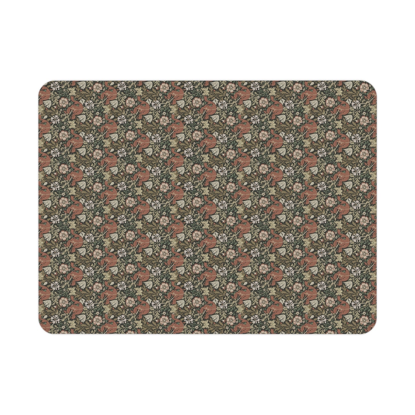 Floral and fox patterned William Morris & Co blanket draped over a crib in a nursery setting.