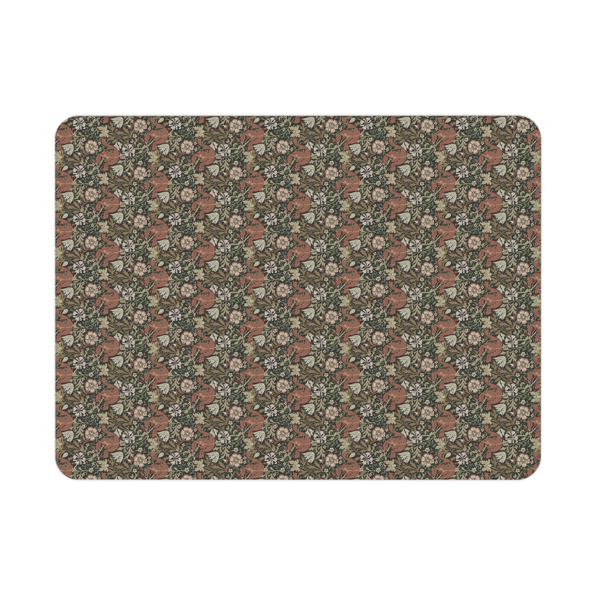 Floral and fox patterned William Morris & Co blanket draped over a crib in a nursery setting.