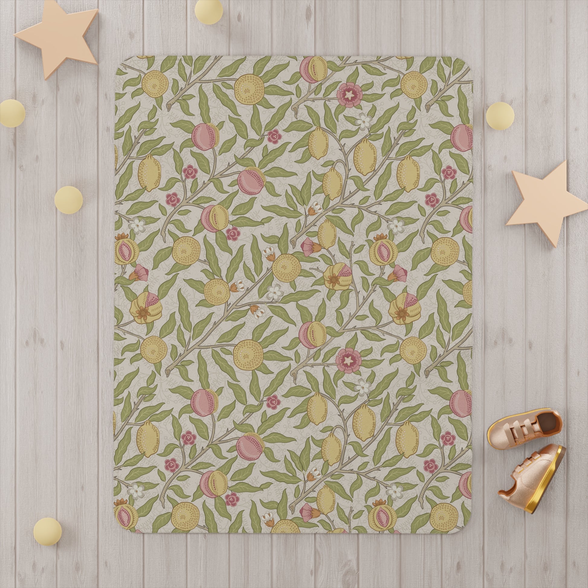 Floral and fruit patterned crib sheet on a white crib