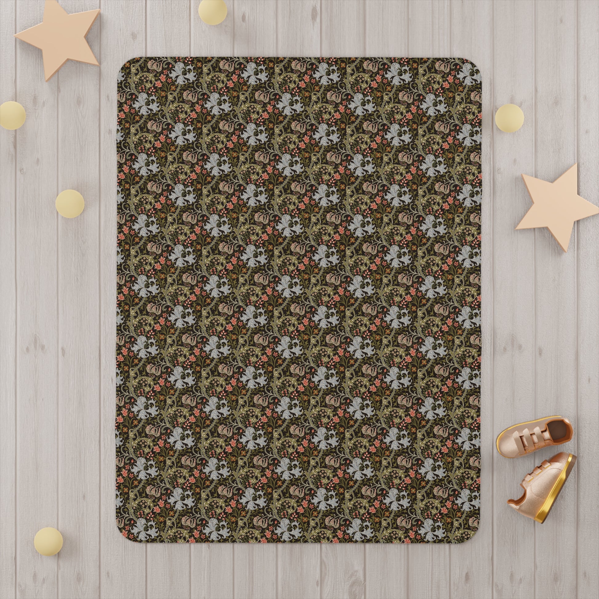 Floral patterned rug on a wooden floor with decorative stars and shoes around it.