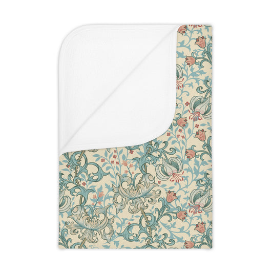 Floral patterned blanket with white border on a beige background