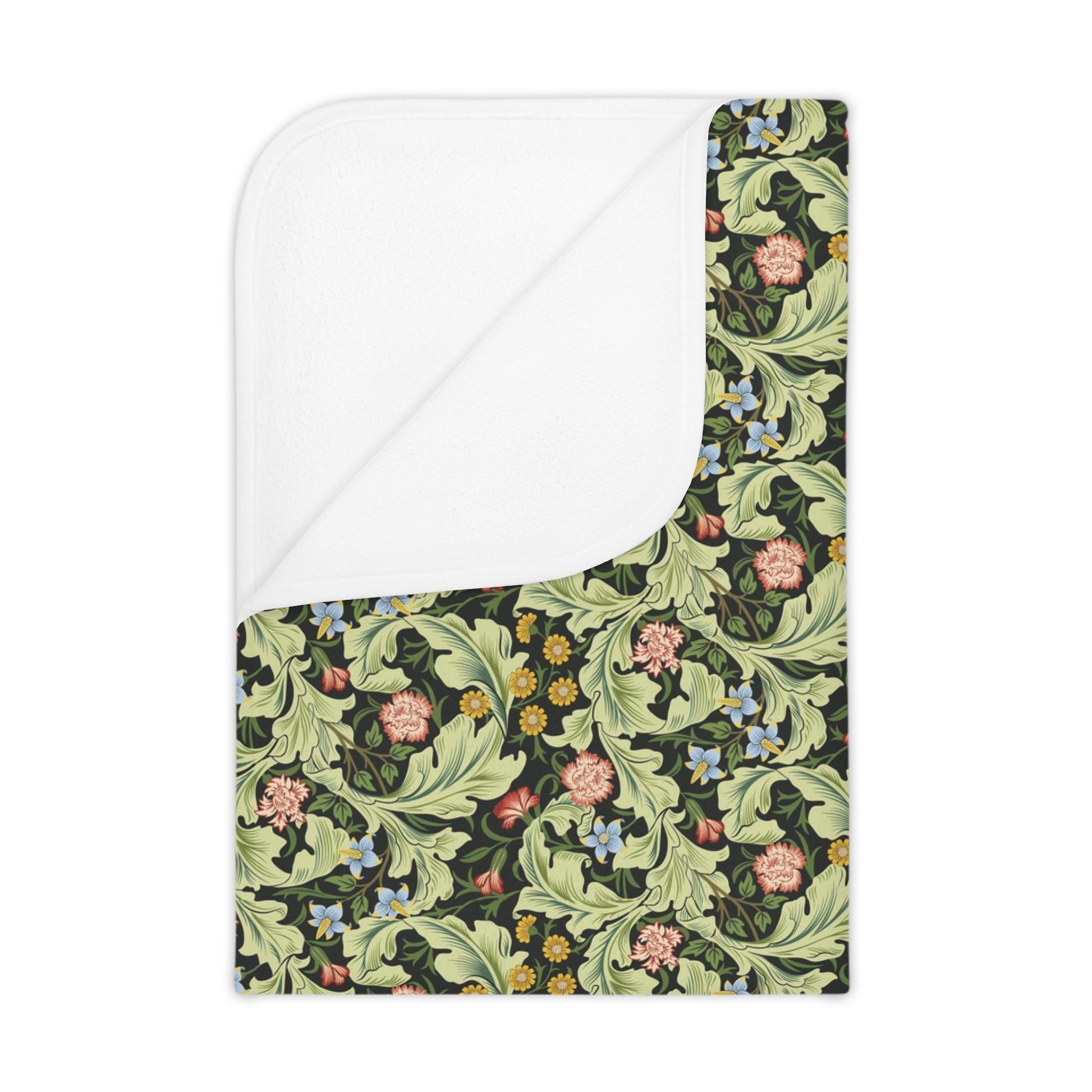 A toddler blanket with a floral pattern in green, inspired by William Morris' Leicester Collection.