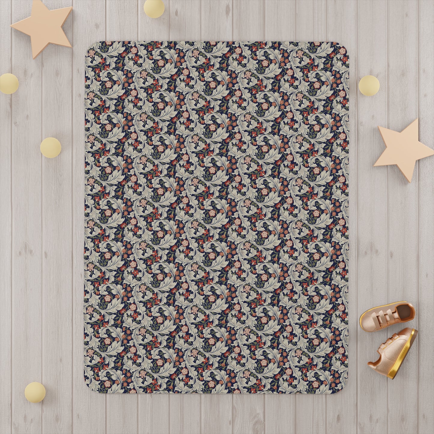 A toddler blanket with a floral pattern inspired by William Morris, in vibrant colours on a white background.