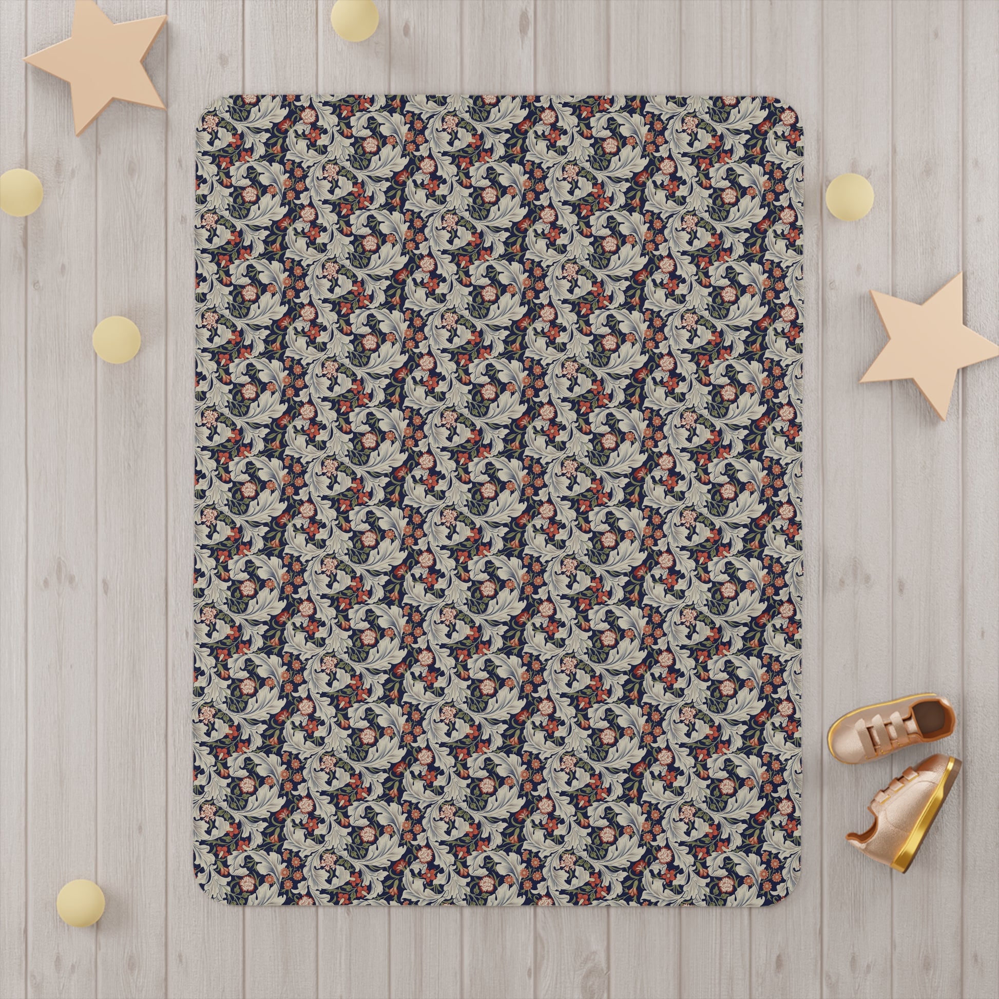 A toddler blanket with a floral pattern inspired by William Morris, in vibrant colours on a white background.
