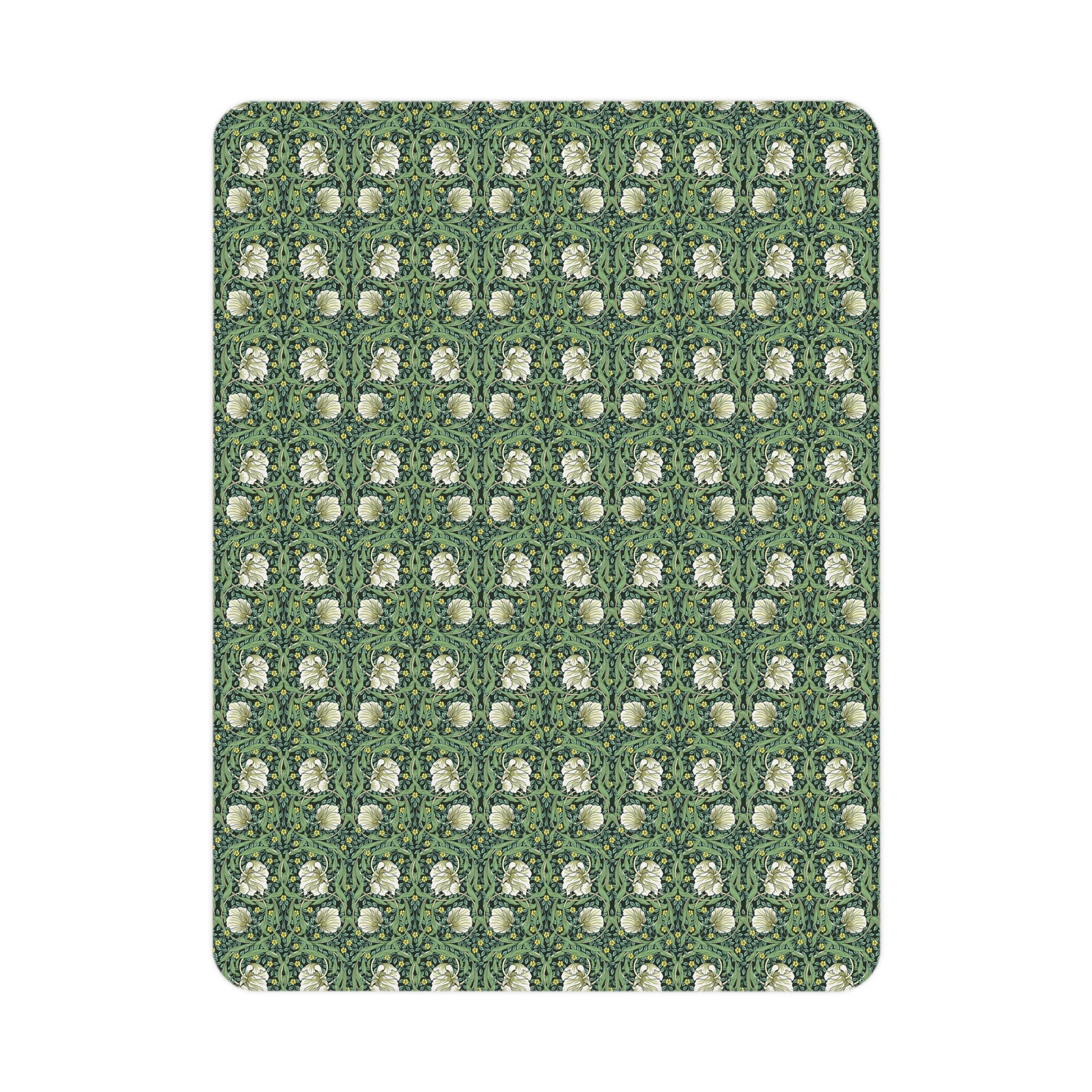 Green floral William Morris & Co Pimpernel patterned toddler blanket draped over a crib