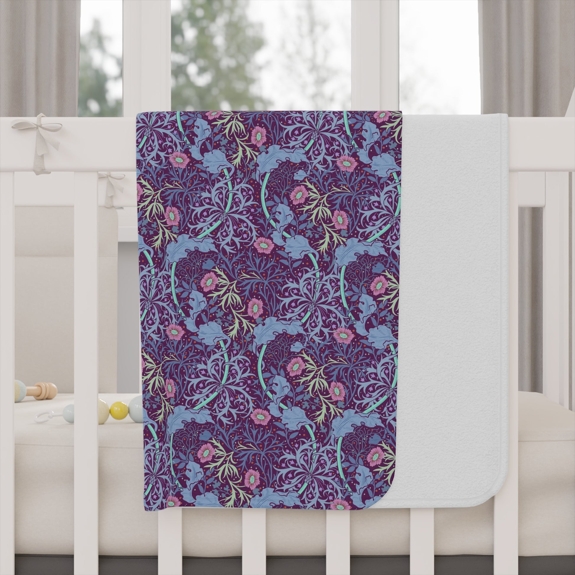 Floral patterned blanket draped over a crib