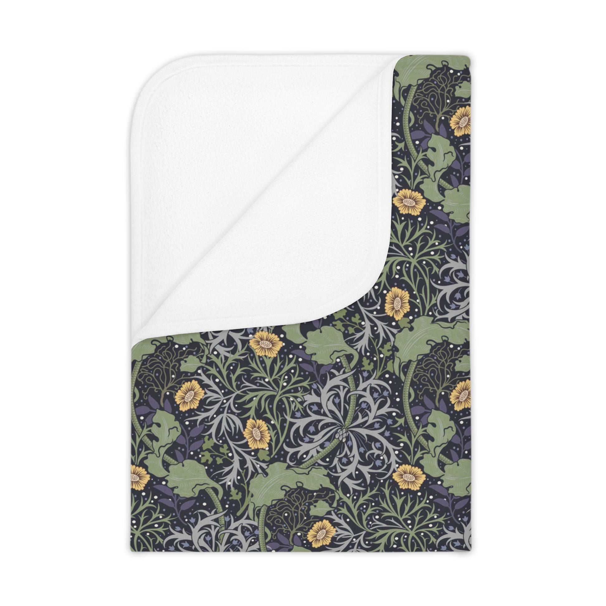 A toddler blanket with a floral pattern inspired by William Morris, featuring yellow flowers on a green background, folded to show both sides.