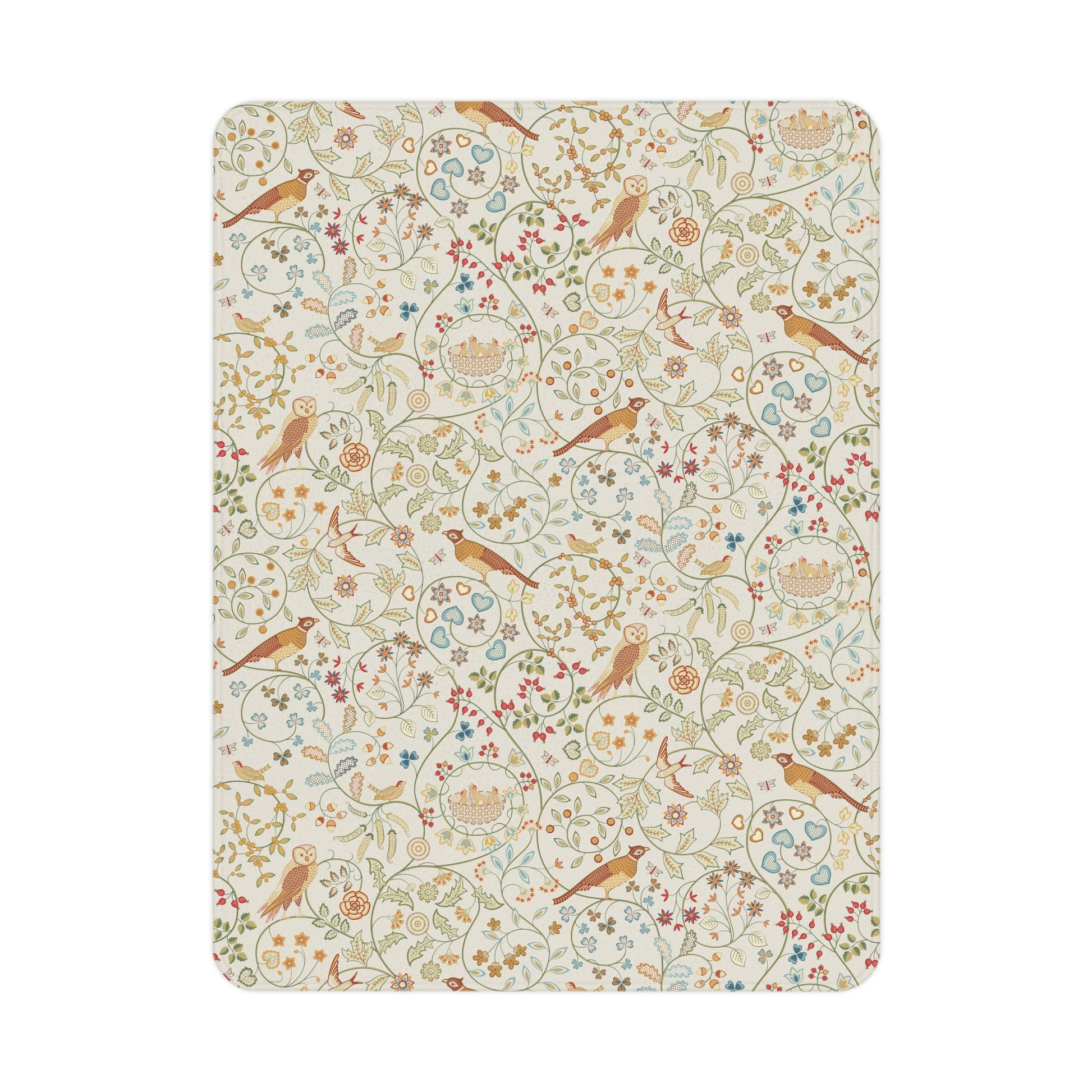 A toddler blanket with a floral and bird pattern inspired by William Morris, in vibrant colours on a light background, folded neatly.