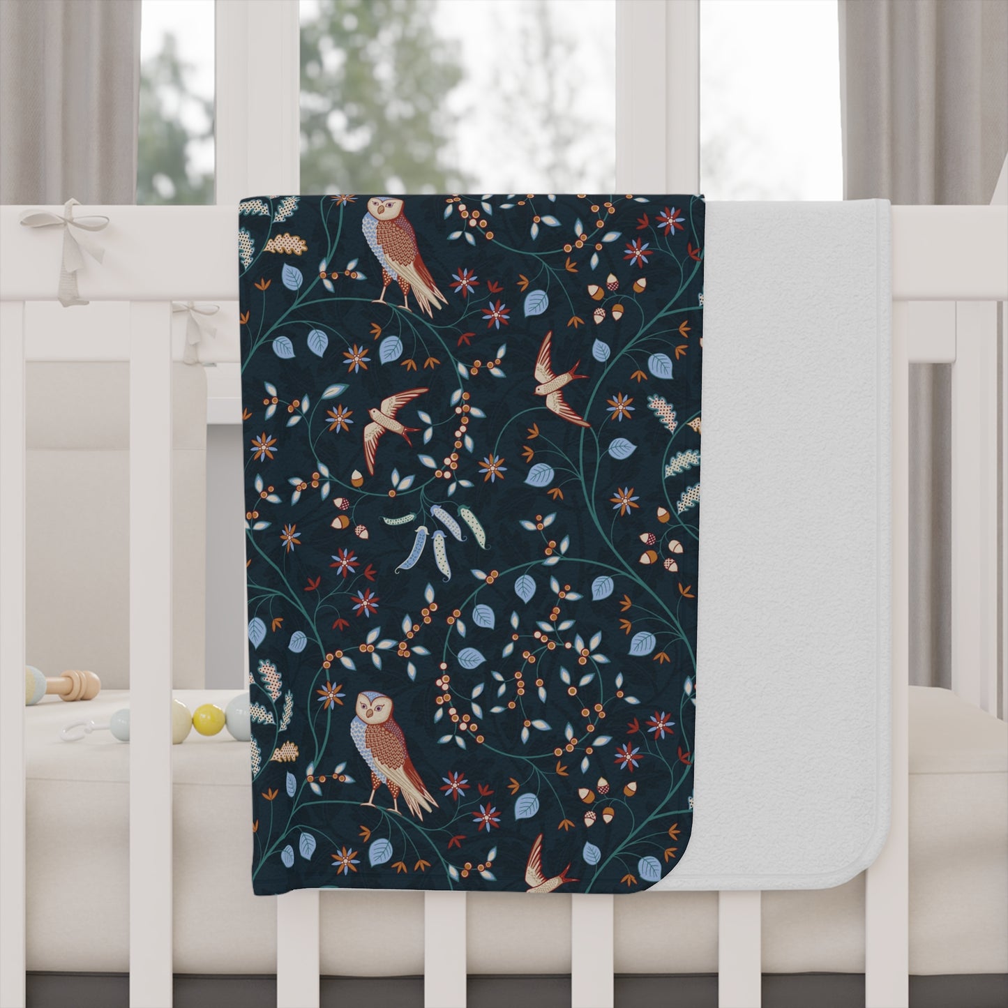 Floral and bird patterned Willy Morris & Co toddler blanket on a white background