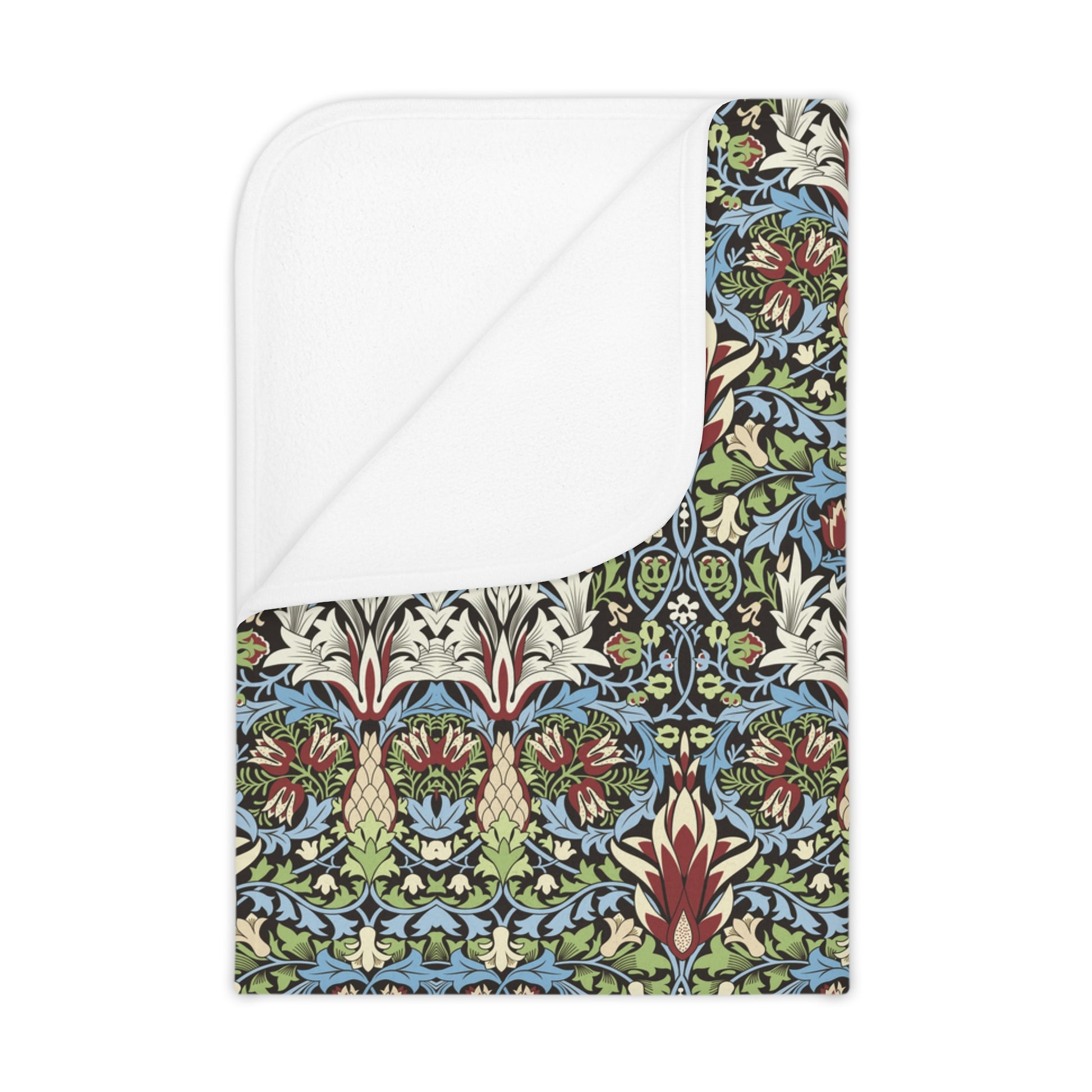 A toddler blanket with a floral pattern inspired by William Morris, featuring colours predominantly in blue, green, and red, with a mix of geometric and organic shapes.