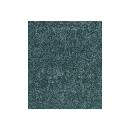 A plush, teal-colored crushed velvet blanket with a floral pattern, folded to show both the front and the silky, lustrous underside.