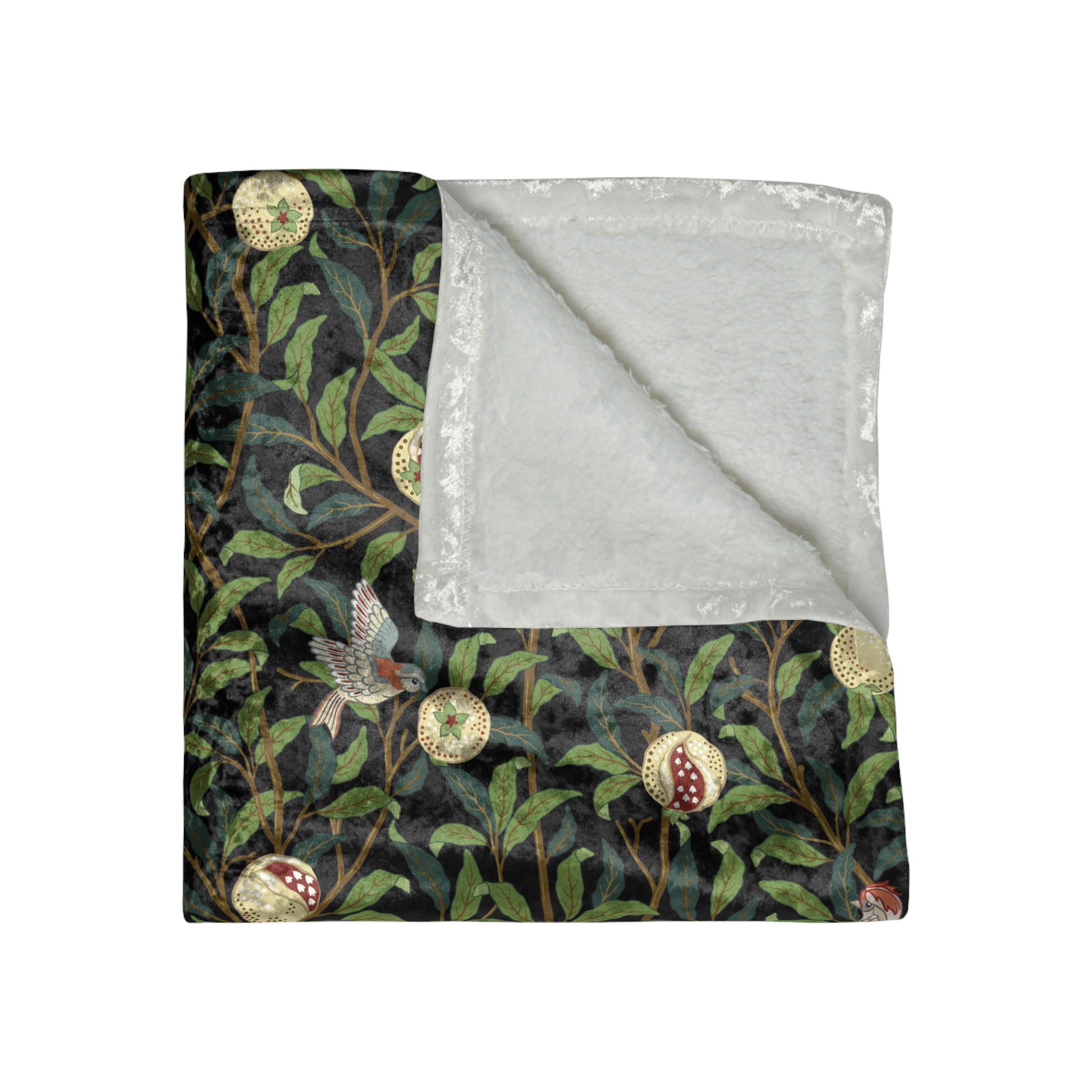 A plush velvet blanket with a one-sided print featuring a bird and pomegranate design on a dark background, with hemmed edges and a silky finish.