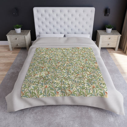 A lush crushed velvet blanket with a floral pattern in green and beige shades, inspired by William Morris' Bird & Pomegranate Collection, displayed on a white background.