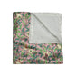 A plush, floral patterned velvet blanket with hemmed edges, inspired by William Morris' Bird & Pomegranate Collection.