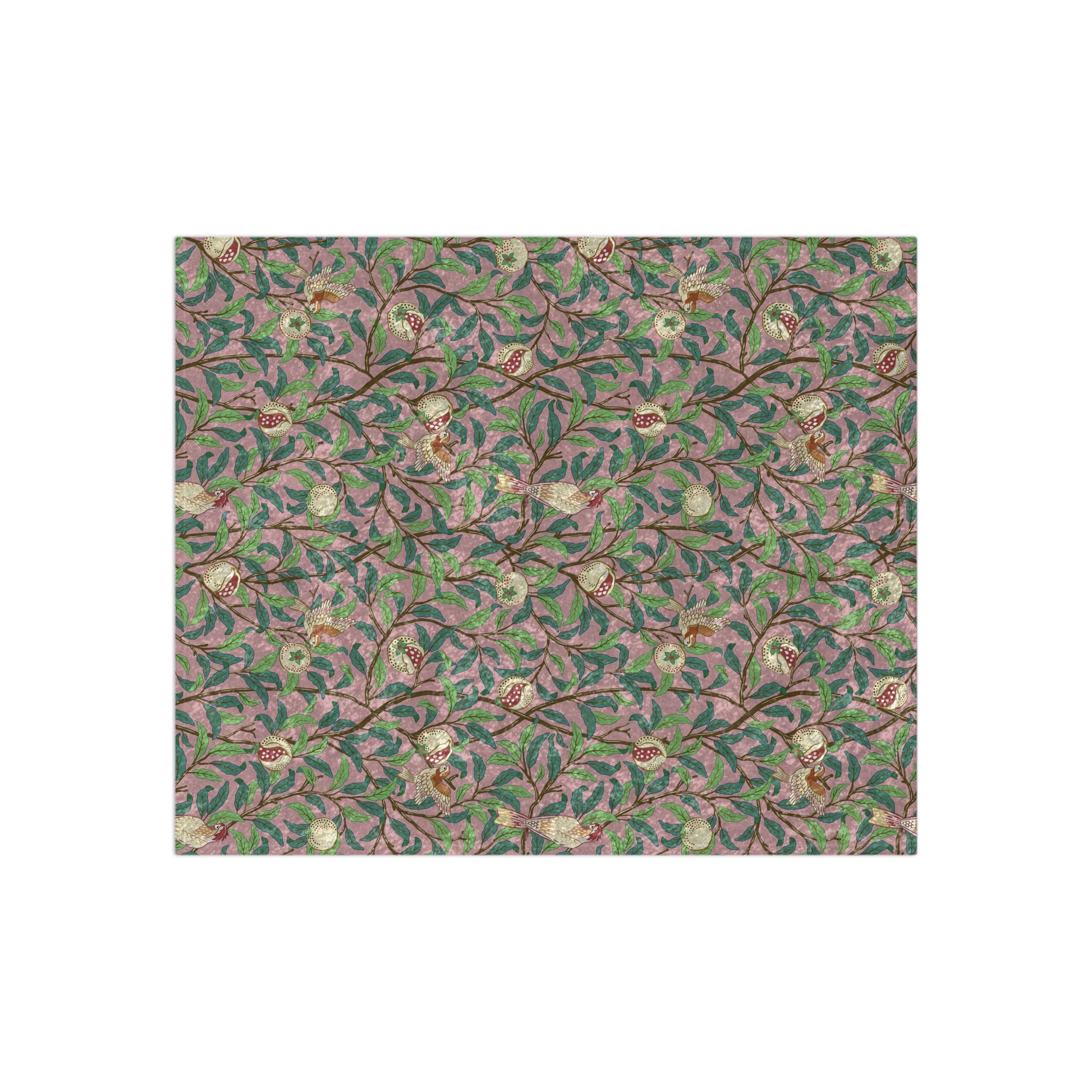 A plush, floral patterned velvet blanket with hemmed edges, inspired by William Morris' Bird & Pomegranate Collection.