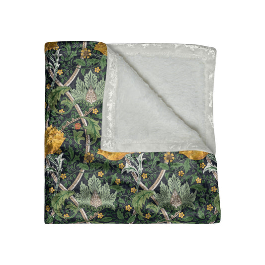 A lush crushed velvet blanket with a William Morris & Co floral pattern in yellow and green shades, displayed on a white background.