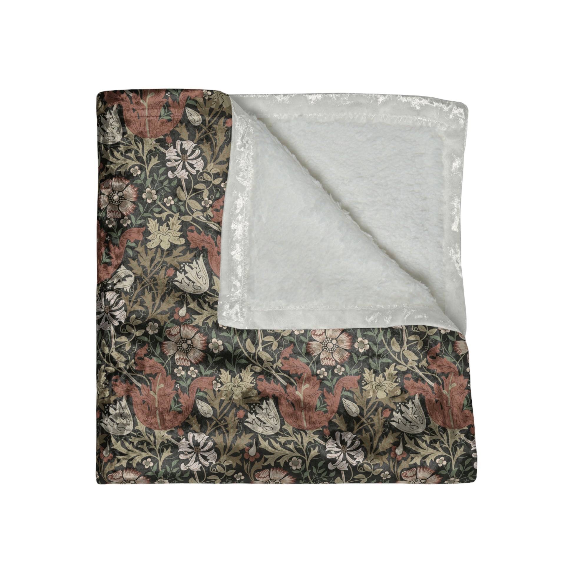 A crushed velvet blanket with a floral William Morris & Co pattern in muted colours and a silky finish.