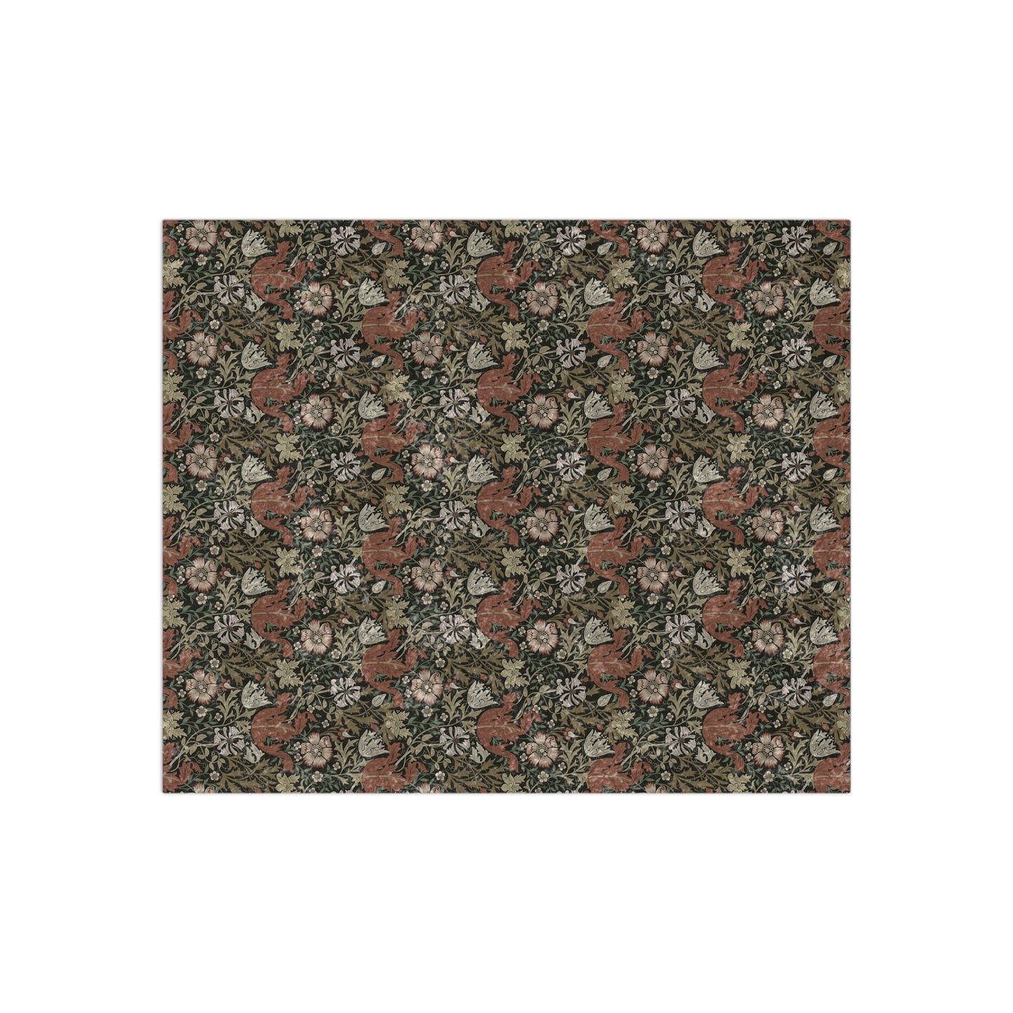 A crushed velvet blanket with a floral William Morris & Co pattern in muted colours and a silky finish.