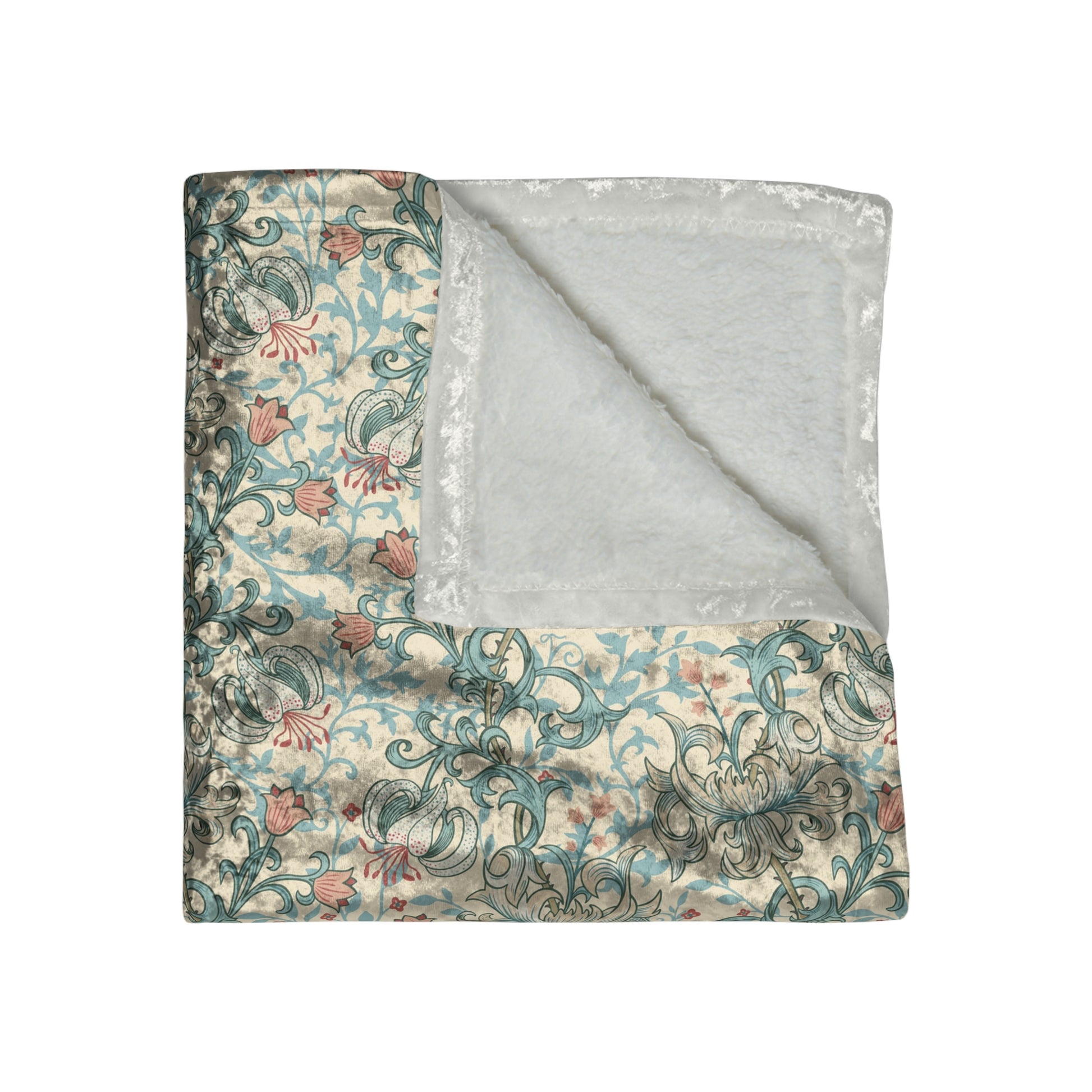 A plush velvet blanket with a floral pattern in a mineral colour palette, folded neatly to show both the patterned side and the silky reverse.