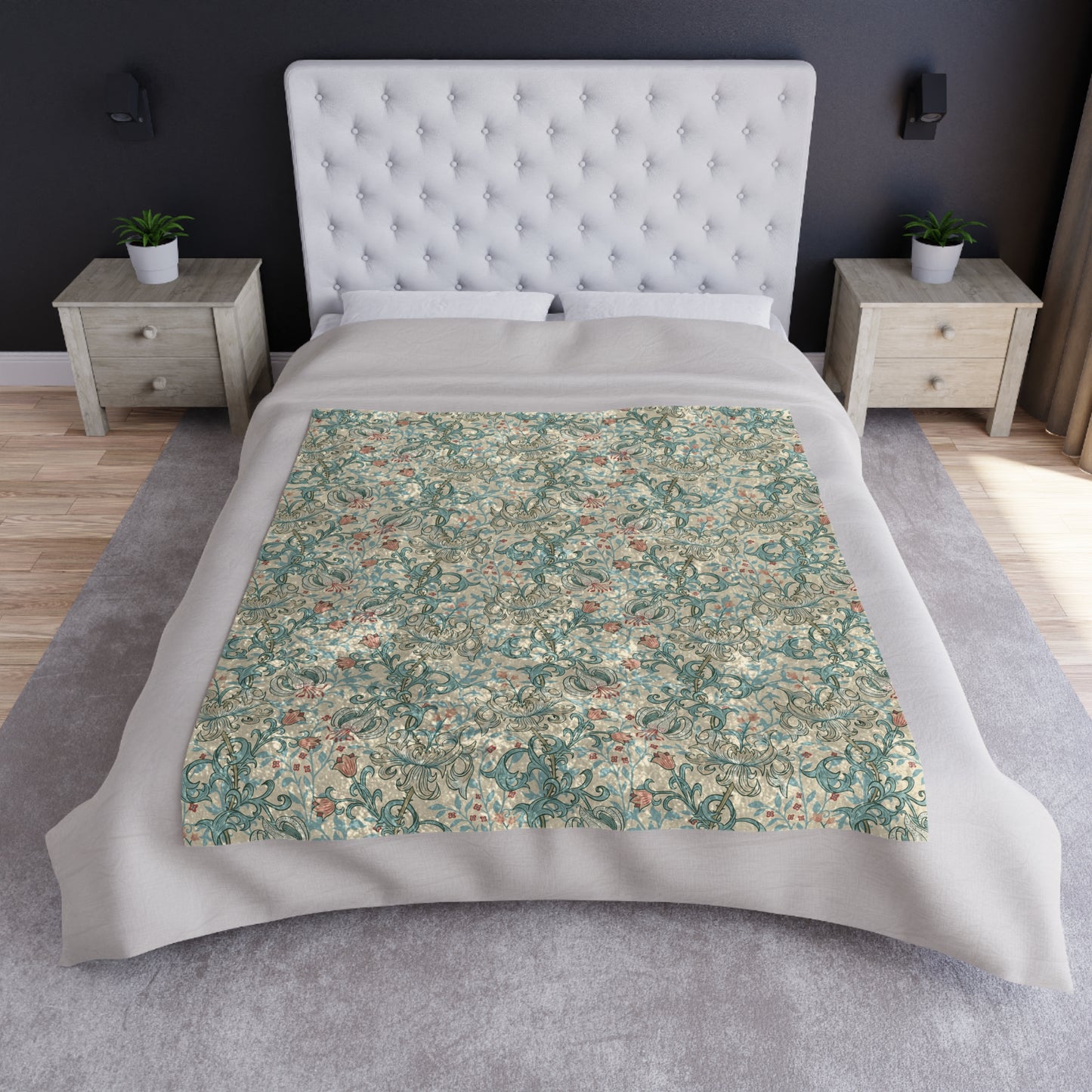 A plush velvet blanket with a floral pattern in a mineral color palette, folded neatly to show both the patterned side and the silky reverse.