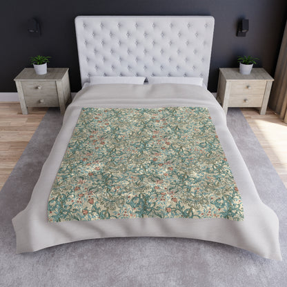A plush velvet blanket with a floral pattern in a mineral color palette, folded neatly to show both the patterned side and the silky reverse.