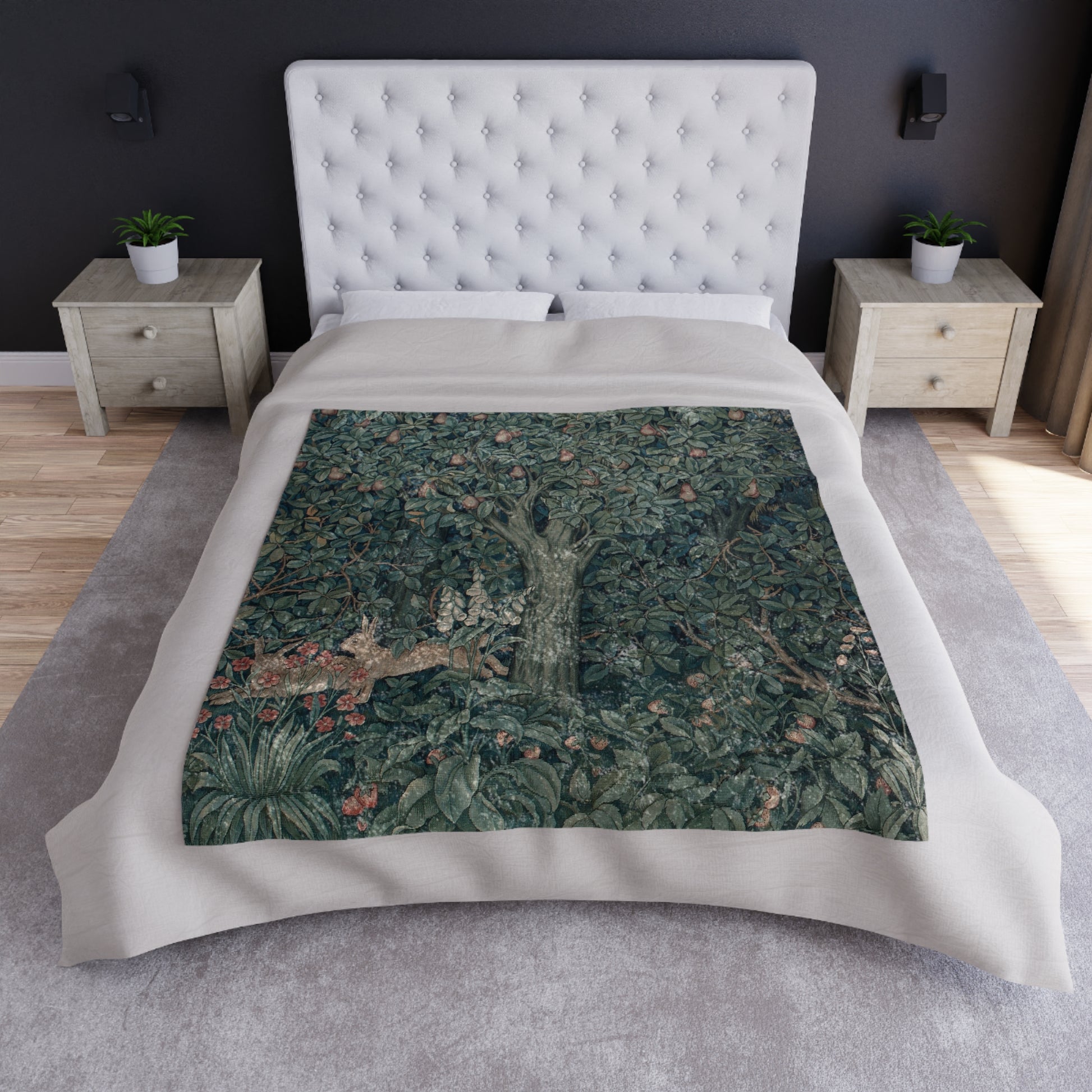 A lush crushed velvet blanket with a greenery and rabbit pattern on one side and a solid silver reverse.