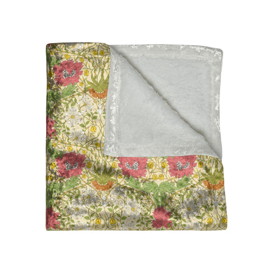 A lush crushed velvet blanket with a floral William Morris & Co pattern in shades of green, pink, and yellow, hemmed edges, and a silky finish.