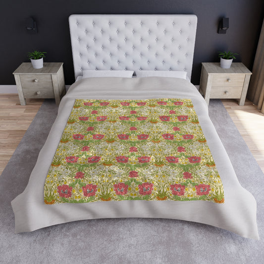 A lush crushed velvet blanket with a floral pattern in shades of green, pink, and yellow, hemmed edges, and a silky finish.