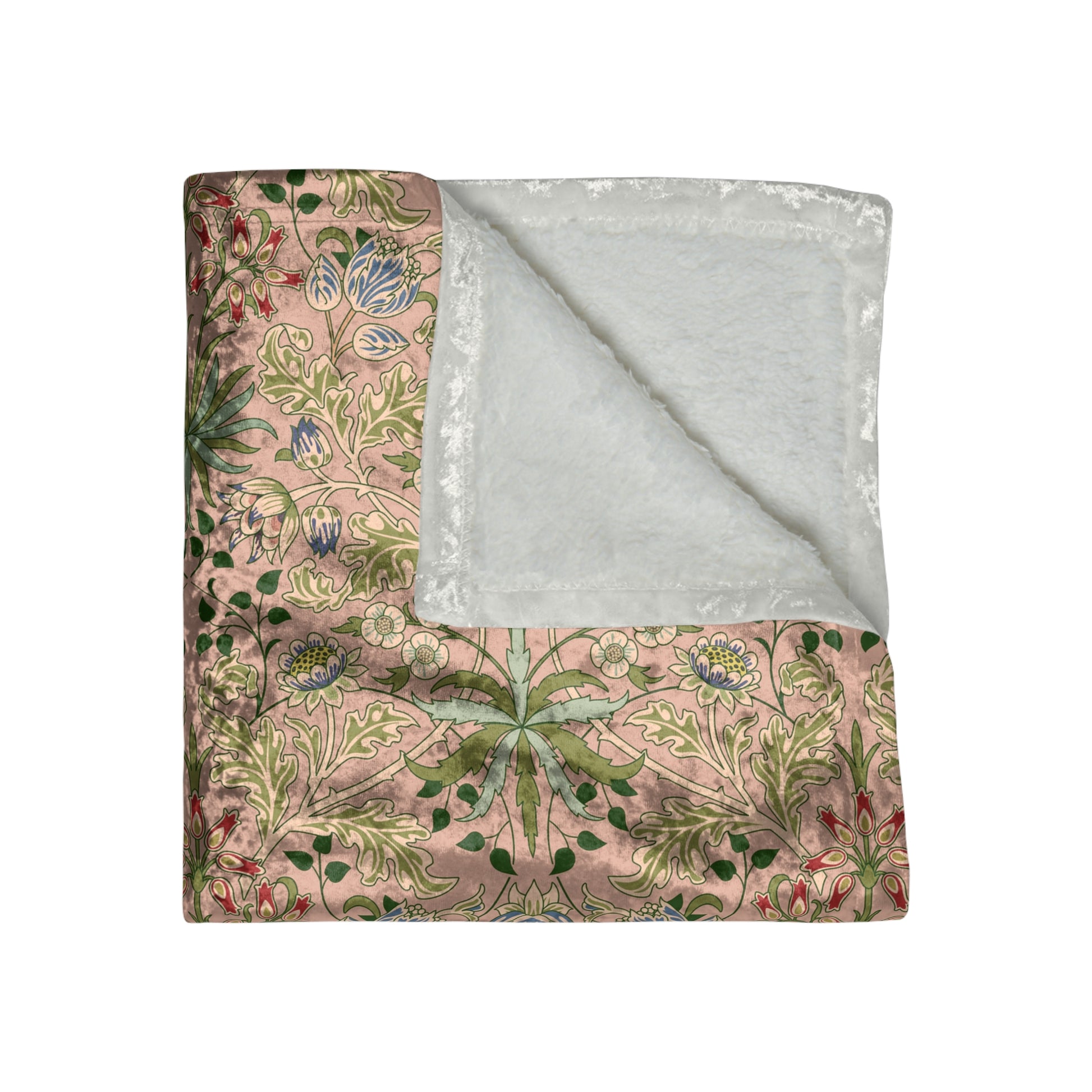 A plush velvet blanket with a floral William Morris & Co pattern in shades of pink and green, with a silky finish.