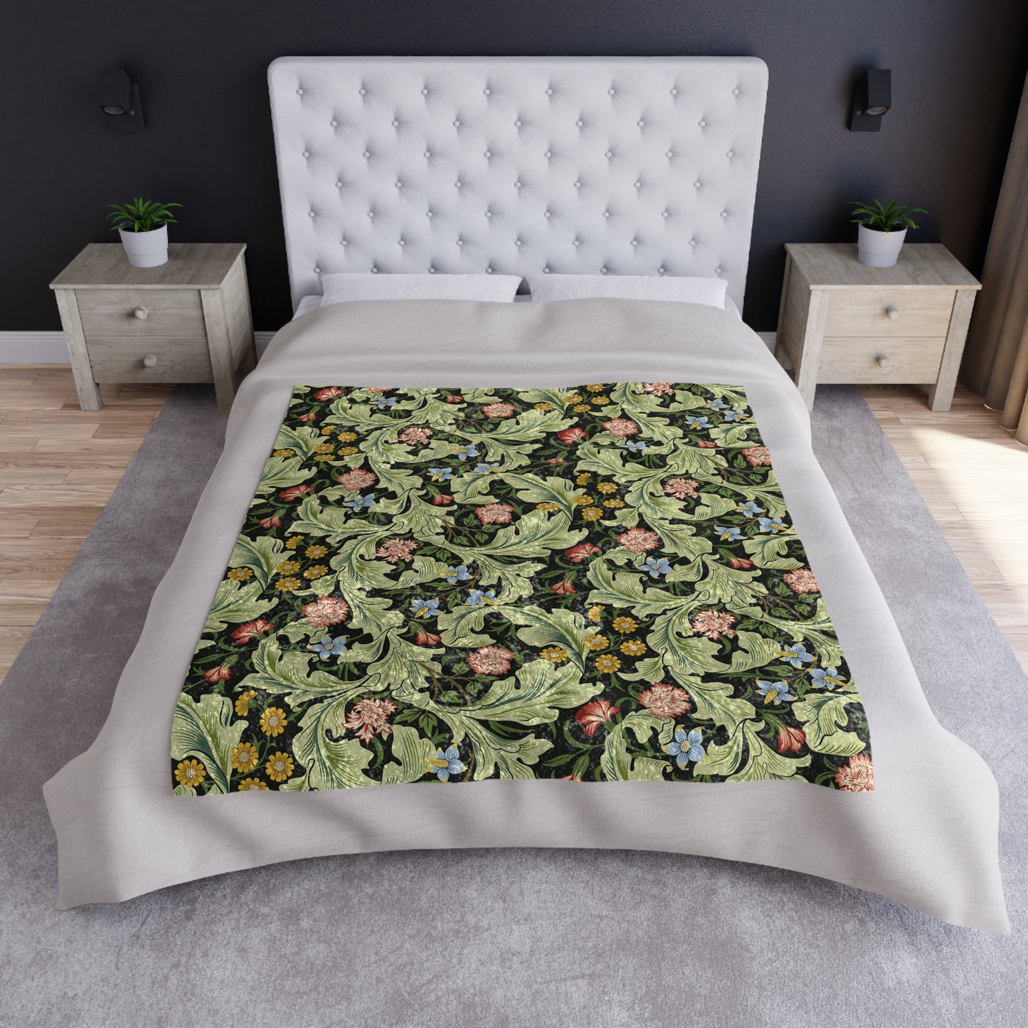 A lush crushed velvet blanket with a floral pattern in green, inspired by William Morris, with hemmed edges and a silky finish.