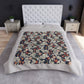 A lush crushed velvet blanket with a floral William Morris & Co pattern in shades of blue, red, and white, hemmed edges, and a silky finish.