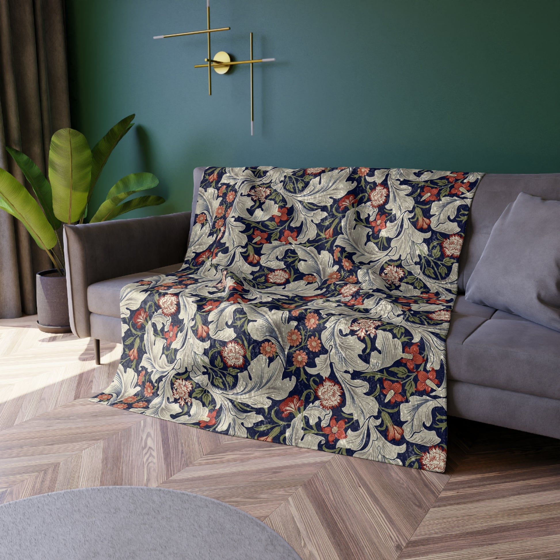 A lush crushed velvet blanket with a floral William Morris & Co pattern in shades of blue, red, and white, hemmed edges, and a silky finish.